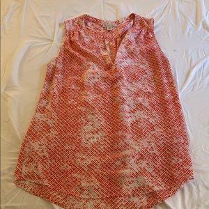 Red patterned sleeveless blouse